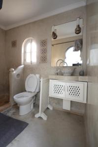 a bathroom with a toilet and a sink and a mirror at Maison de vacances avec vue mer in Essaouira