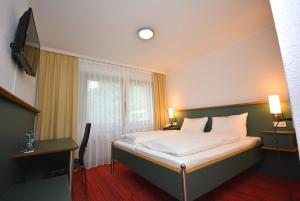Ένα ή περισσότερα κρεβάτια σε δωμάτιο στο Hotel Kehrenkamp