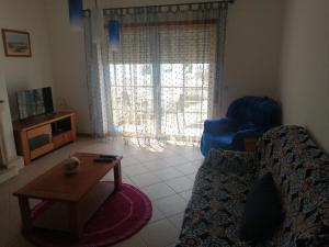 a living room with a couch and a table at Casa Campos in Nazaré