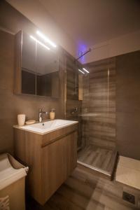 a bathroom with a sink and a shower at Luxury Studios Kallithea by Corfuescapes in Kanálion +92 photos