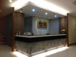 a hotel lobby with ajit pay sign on the wall at Bird Day Boutique Hotel in Mukdahan