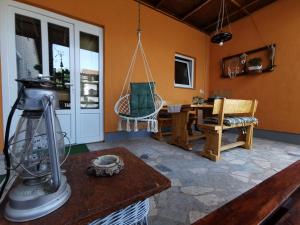 a living room with a table and a swing at Studio apartman Krosna in Perušić