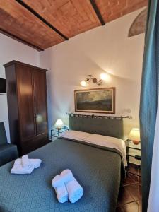 Postel nebo postele na pokoji v ubytování Saturnia Residence