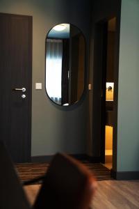 a room with a mirror and a door with a window at Konvin Hotel by Reykjavik Keflavik Airport in Keflavík