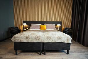 a bedroom with a large bed with yellow pillows at Konvin Hotel by Reykjavik Keflavik Airport in Keflavík