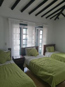 Giường trong phòng chung tại Hotel Beraka Boutique