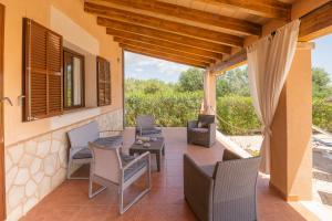 an outdoor patio with chairs and a table at Villa Son Sala Nou in Campos