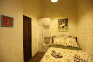 a small bedroom with a bed and a mirror at Luky apartment on Rustaveli Ave. in Tbilisi City