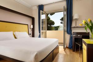 a bedroom with a large bed and a window at Park Hotel Marinetta - Beach & Spa in Marina di Bibbona +86 photos