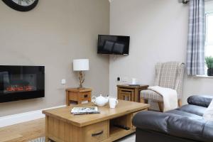 a living room with a couch and a fireplace at Chiff Chaff in Belford