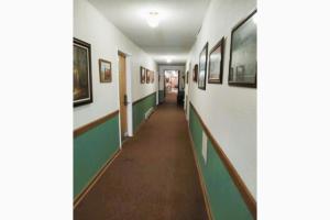 - un couloir dans un bâtiment orné de peintures sur les murs dans l'établissement Love Hotels Voyageur at International Falls MN, à International Falls