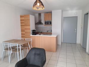 a kitchen and dining room with a table and chairs at le gazounet in Castelsarrasin