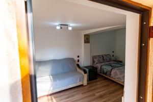 a bedroom with a bed and a mirror at La Bebe 2 Beds in Hunedoara