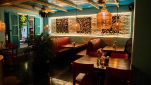 a restaurant with tables and chairs and a brick wall at Hotel Isla de Flores in Flores