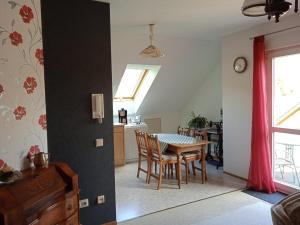 a kitchen and dining room with a table and chairs at Ferienwohnung kaub in Immerath