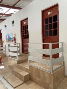 a pair of doors on a building with stairs at Pousada Nossa Casa in Maceió