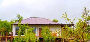 a white house with a red roof and some trees at Green Agarak Guest House near Dendropark, Stepanavan in Gyulagarak