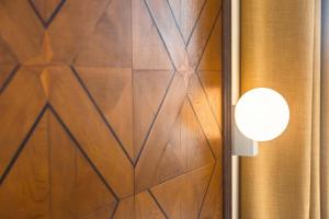 a room with a wooden wall with a light on it at Hotel Dei Dragomanni in Venice