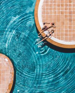 a person floating in a pool of water at Monte Santo Resort in Carvoeiro