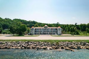 a large building next to a body of water at Gold Coast Inn in Traverse City