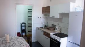 a small kitchen with a sink and a stove at Apartman Filimena in Kruševac