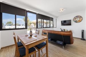 a living room with a table and a piano at Holiday in Lanzarote! in Tías