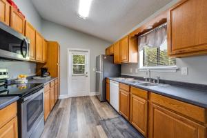 a kitchen with wooden cabinets and a refrigerator at Sunny Lemon in Middleburg
