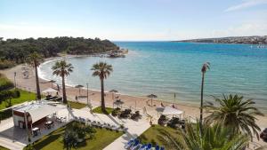 a view of a beach with palm trees and the ocean at Black Pearl in Novalja