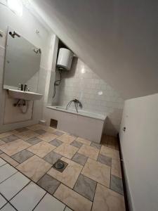 a bathroom with a sink and a tile floor at Villa ''M&A'' in Sarajevo +31 photos