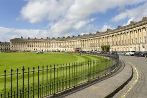 a large building with a green lawn in front of it at No.2 Bloom Apartments, Bath in Bath