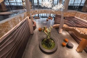 an overhead view of a lobby with a vase of flowers at Kravt Kazan Airport Hotel in Bol'shiye Kabany