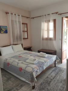 een slaapkamer met een bed met twee handdoeken erop bij Voula Pansion in Kardhamili