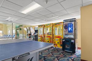 a gaming room with a table and arcade games at Bonita Beach Hotel in Ocean City