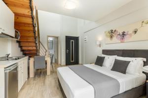 a bedroom with a large bed and a kitchen at Ilis Villas in Nikiti