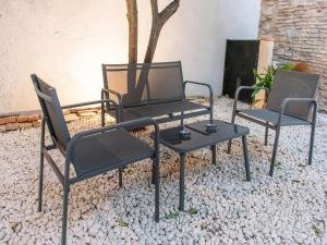 a group of three chairs and a table at Belvilla by OYO Casa Palacio de la Carrera in Fuentes de Andalucía