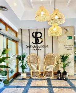 a lobby with wicker chairs in front of a store at Soho Boutique Puerto in El Puerto de Santa María +107 photos