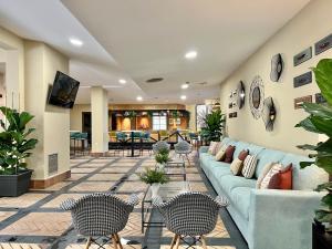a living room with a blue couch and chairs at Soho Boutique Puerto in El Puerto de Santa María