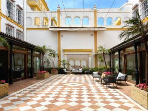 a courtyard of a building with a checkered floor at Soho Boutique Puerto in El Puerto de Santa María