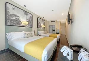 a hotel room with two beds and a television at Soho Boutique Puerto in El Puerto de Santa María +110 photos