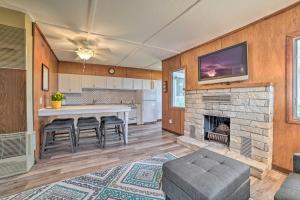 a kitchen and living room with a fireplace at Cozy Petoskey Area Retreat on Burt Lake Access! 