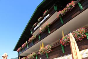 a building with flower boxes on the side of it at Hotel Sonnleiten in Reit im Winkl