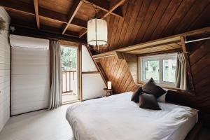 Katil atau katil-katil dalam bilik di LOGIN OKINAWA -country-