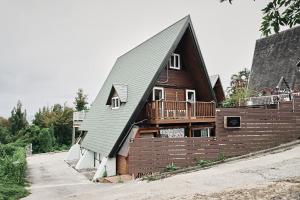 a house with a gambrel roof with a deck at LOGIN OKlNAWA -counrty- in Onna