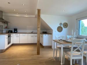 a kitchen and dining room with a table and chairs at Mansarde “Sabine“ in Montabaur