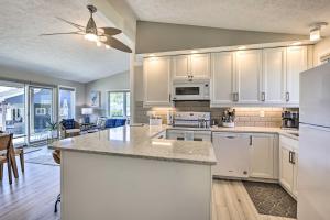a kitchen with white cabinets and a large island at Lakefront Bellevue Home Private Beach and Fire Pit! in Bellevue
