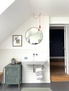 a bathroom with a sink and a mirror at Unique 2 Bedroom Penthouse Apartment in Kensal Rise in London