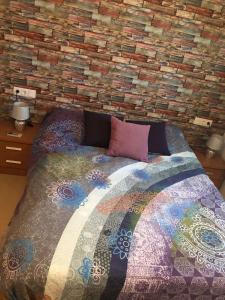 a bedroom with a bed with a brick wall at "La Piña" Condado Golfresort 1574 in Alhama de Murcia