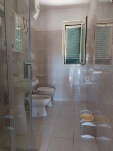 a bathroom with a toilet and a sink and a shower at La Dimora dei Pescatori in Vieste
