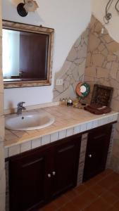 a bathroom with a sink and a mirror at Risveglio sull'Etna in Belpasso
