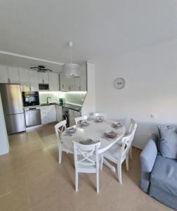 a living room with a table and chairs and a kitchen at Casa Soñada - Dream House in Garrucha +24 photos